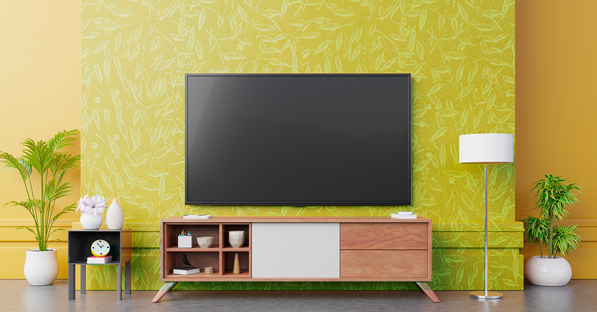 Tv unit and a wall mounted TV on yellow  textured wall