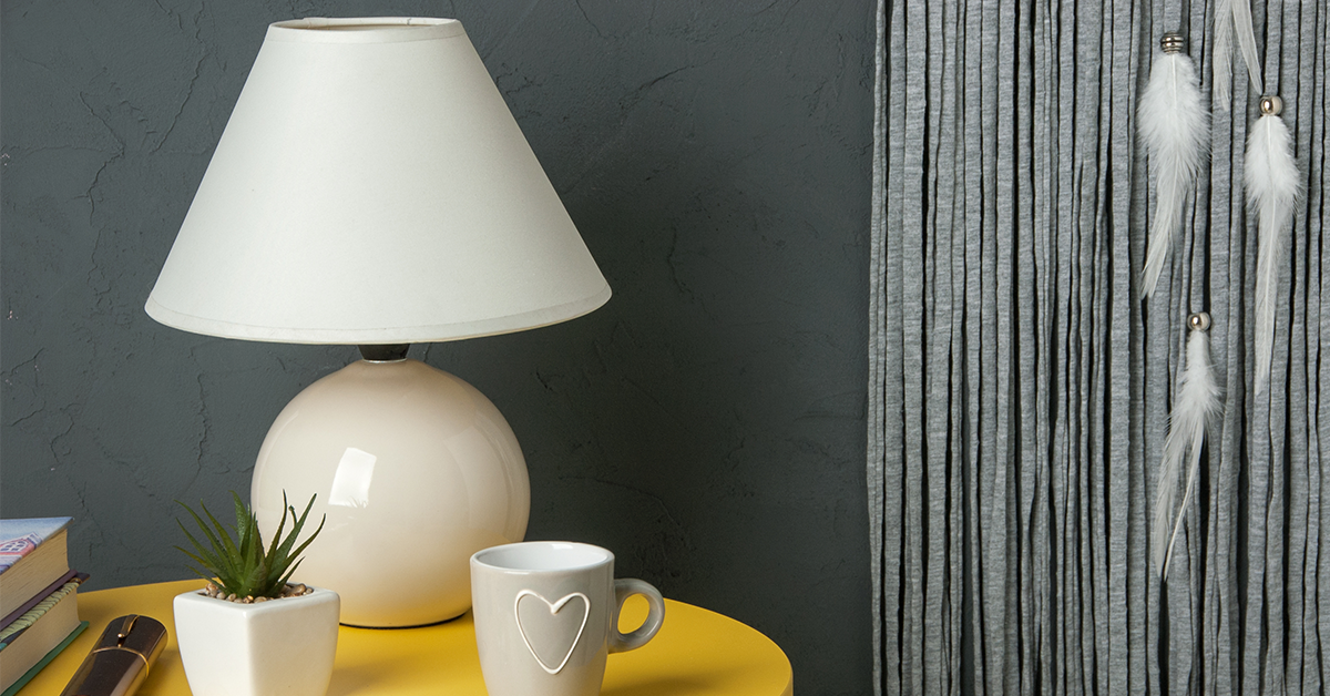 White table lamp next to a dark wall