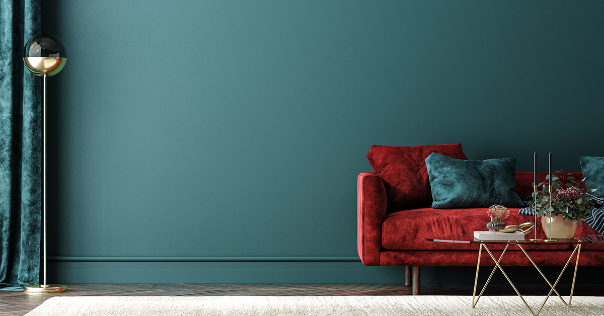 Beautiful living room wall painted blue with red sofa