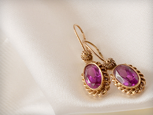 Golden earings with purple gems