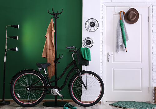 Black Bicycle In A Living Room With Green Wall