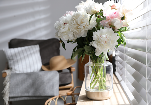 White Flowers In A Vase By The Window