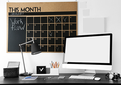 Work Desk With A Calender On The Wall
