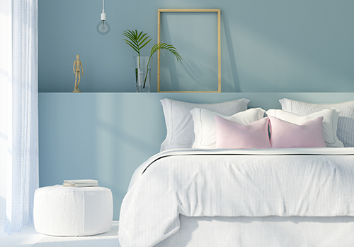 Light Blue Colour Wall and A White Bed
