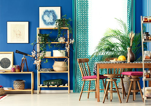 Blue Wall With Wooden Furniture And Plant Décor For A Living Room