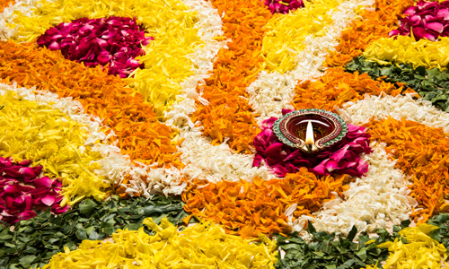 diwali floral rangoli with diya